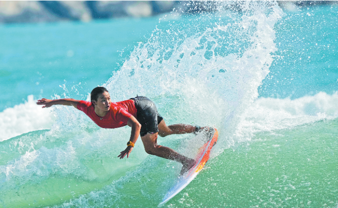 RIDING THE CREST OF A WAVE History making teen surfer Yang wins shortboard gold, cementing her position as nation's top shredder